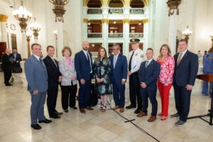 Sen. Lisa Baker (center) with Detective Kyle Gilmartin to her left, along with legislative and public safety officials following today’s press conference.