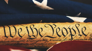 We The People with American flag in background
