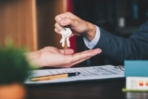 House keys are being dropped into hands.