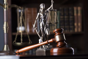 gavel and scales of justice in a law library