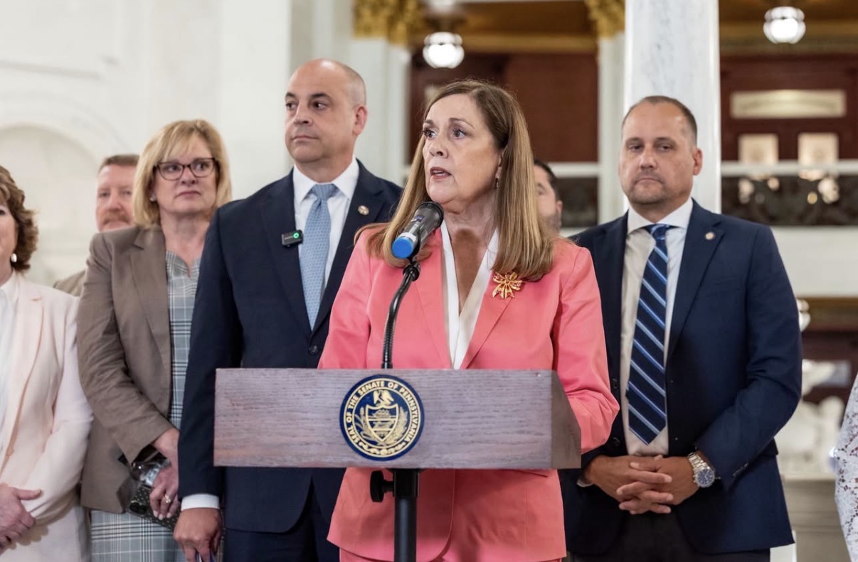 Sen. Baker standing behind a podium while speaking at a press conference with Pennsylvania Attorney General Dave Sunday at the state capitol.