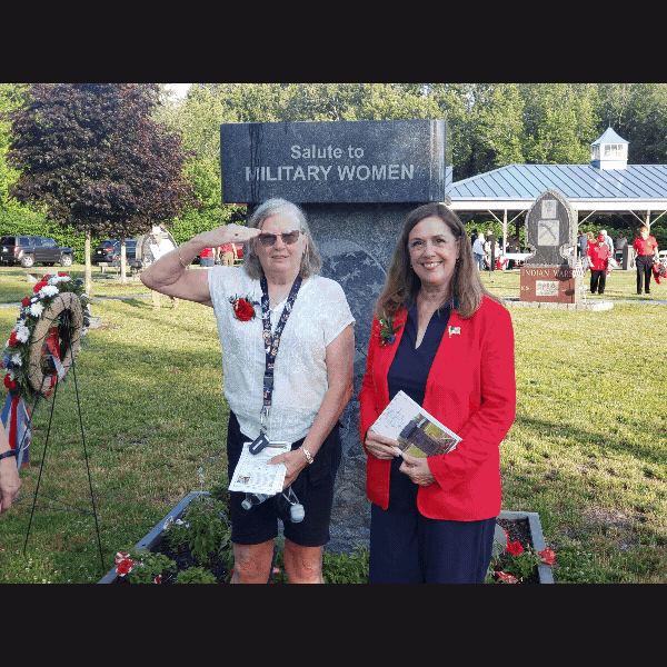 Slideshow of Women Veterans Day celebration, showing Sen. Baker with Pike County commissioners and female residents from Gino J. Merli Veterans’ Center, members of Pike County stand in the background, gathered in small groups and talking with one another. Three female scouts in uniform stand in front of Salute to Military Women stone monument, facing forward with proud, attentive posture.