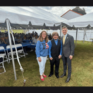 Slideshow of Sen. Baker with Rev. Gurka, Rep. Ryncavage, and community members at St. John bazar grounds.