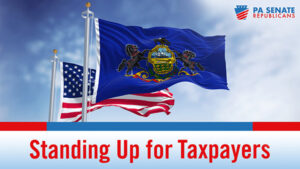 American flag flying behind the Pennsylvania flag with the words Standing Up for Taxpayers beneath.