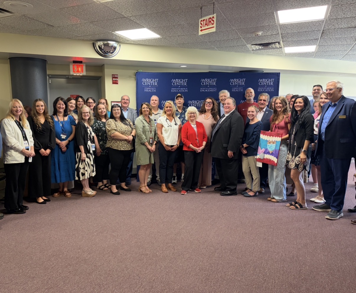 Group photo shows The Wright Center’s president, CEO, and staff standing alongside Wyoming County healthcare team.