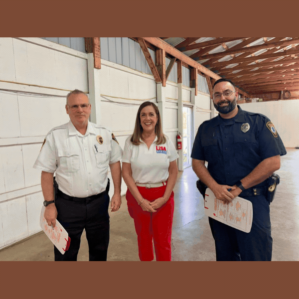 Sen. Baker with Dallas Borough Police at Luzerne County Fairgrounds, cars lined up in garage while staff and police help fill out forms