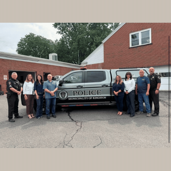 Sen. Baker & Rep. Pugh with Kingston Municipal Police Department in front of new gray and black “Police Municipality of Kingston” truck parked outside of municipal building